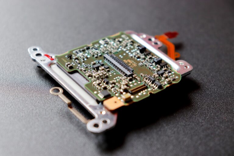 Primer plano detallado de un microchip sobre una superficie oscura, representando la arquitectura de los sistemas embebidos.